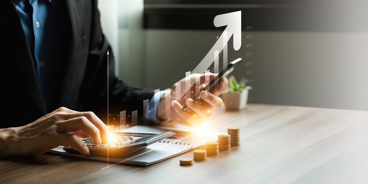 A businessman calculates growth using a calculator and coins, symbolizing financial analysis and strategic planning.